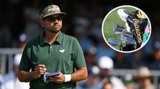 Jason Day writes in his yardage book, while looking at a golf bag