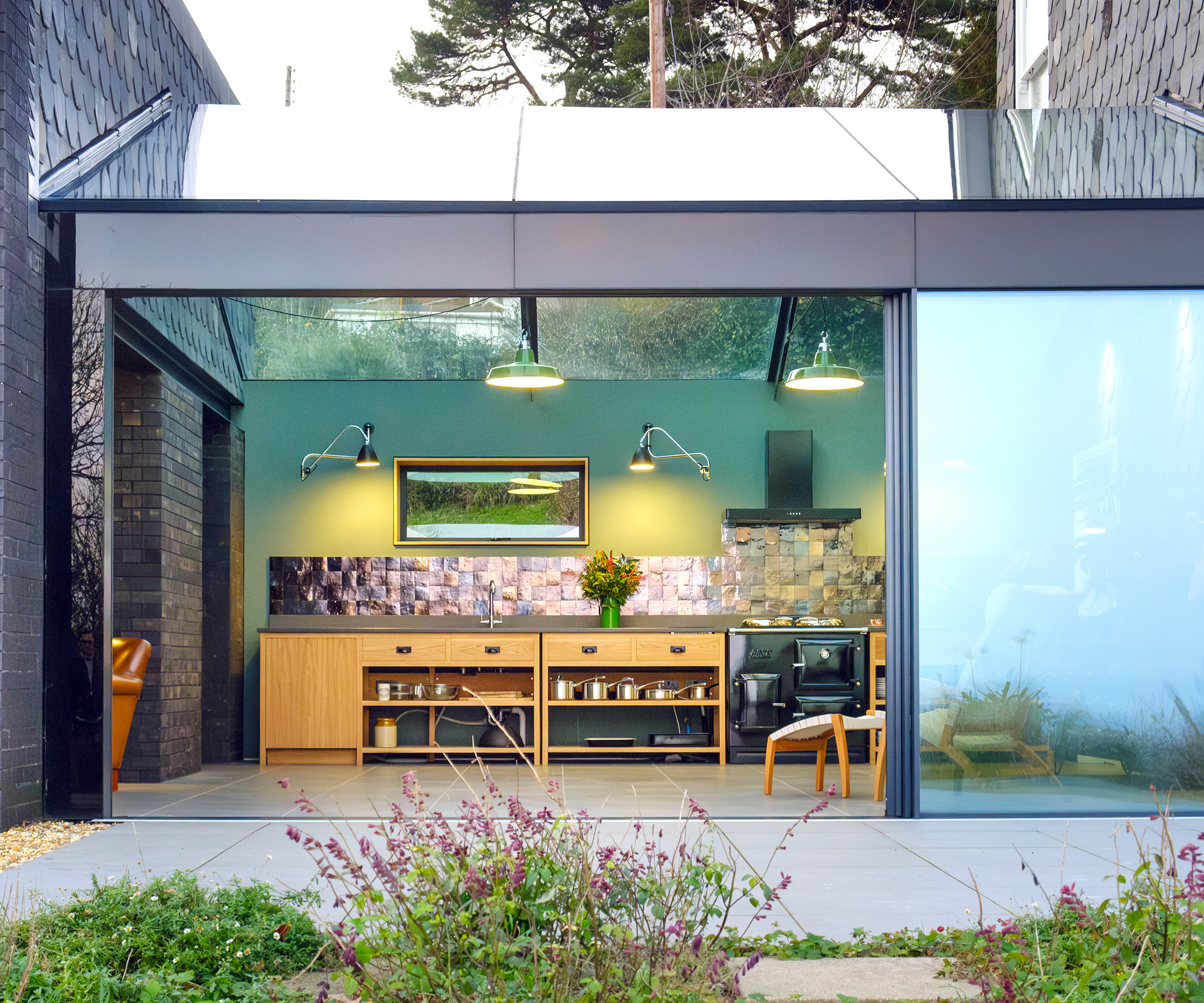 A glass link containing a kitchen between the original house and a new building