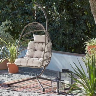 Homebase foldable hanging egg chair on a garden patio