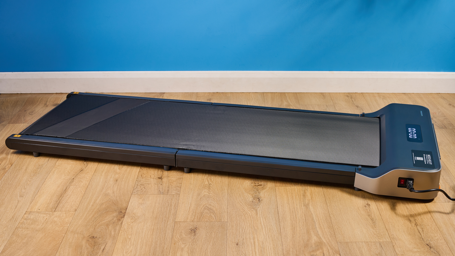 The WalkingPad Z1 photographed in front of a blue background.