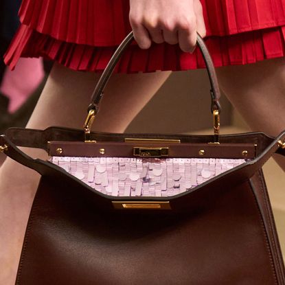 a close-up of a Fendi bag from Spring 2026 with a pink sequin interior