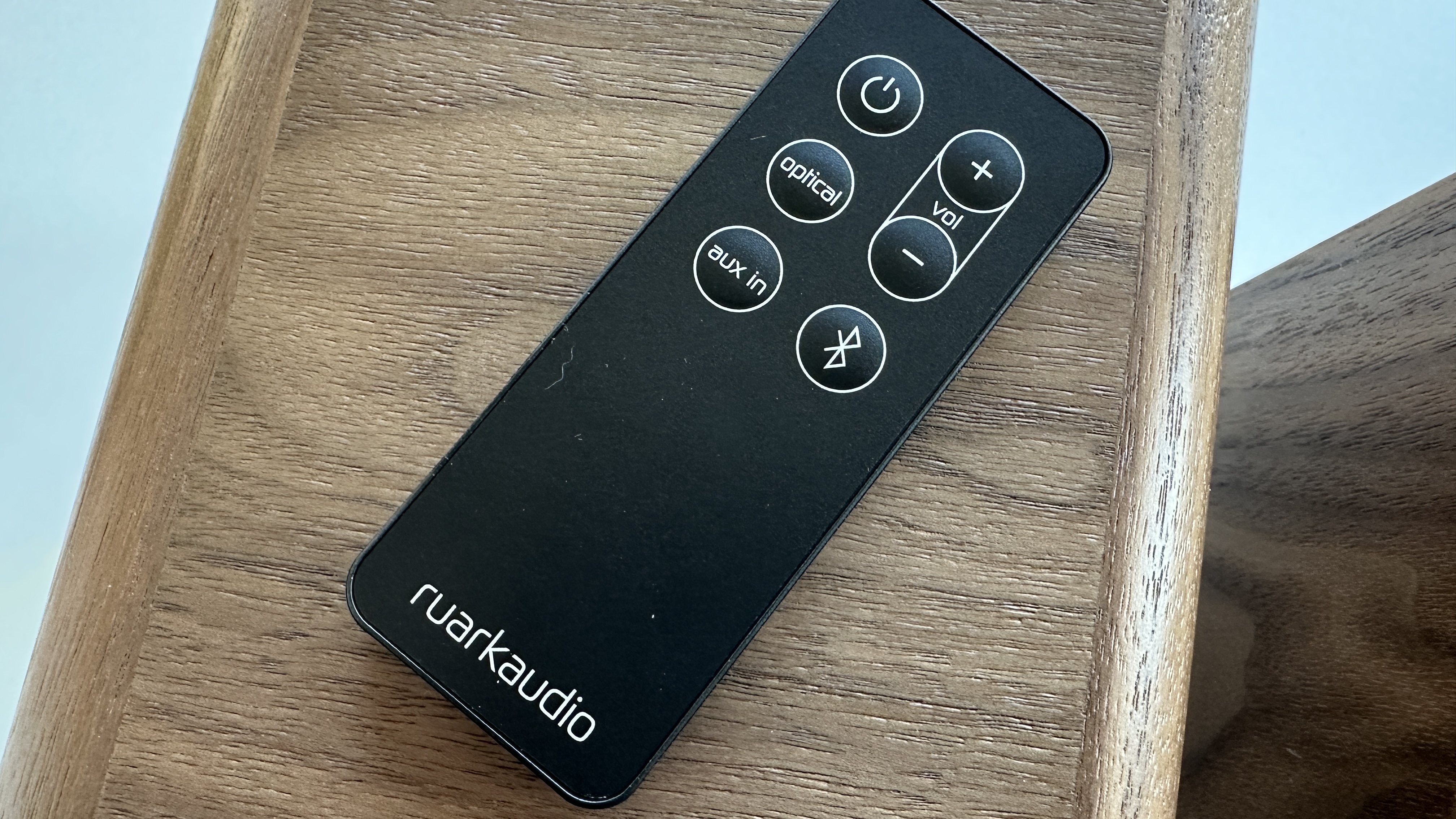 Ruark MR1 MkII remote control, sitting on a wooden surface
