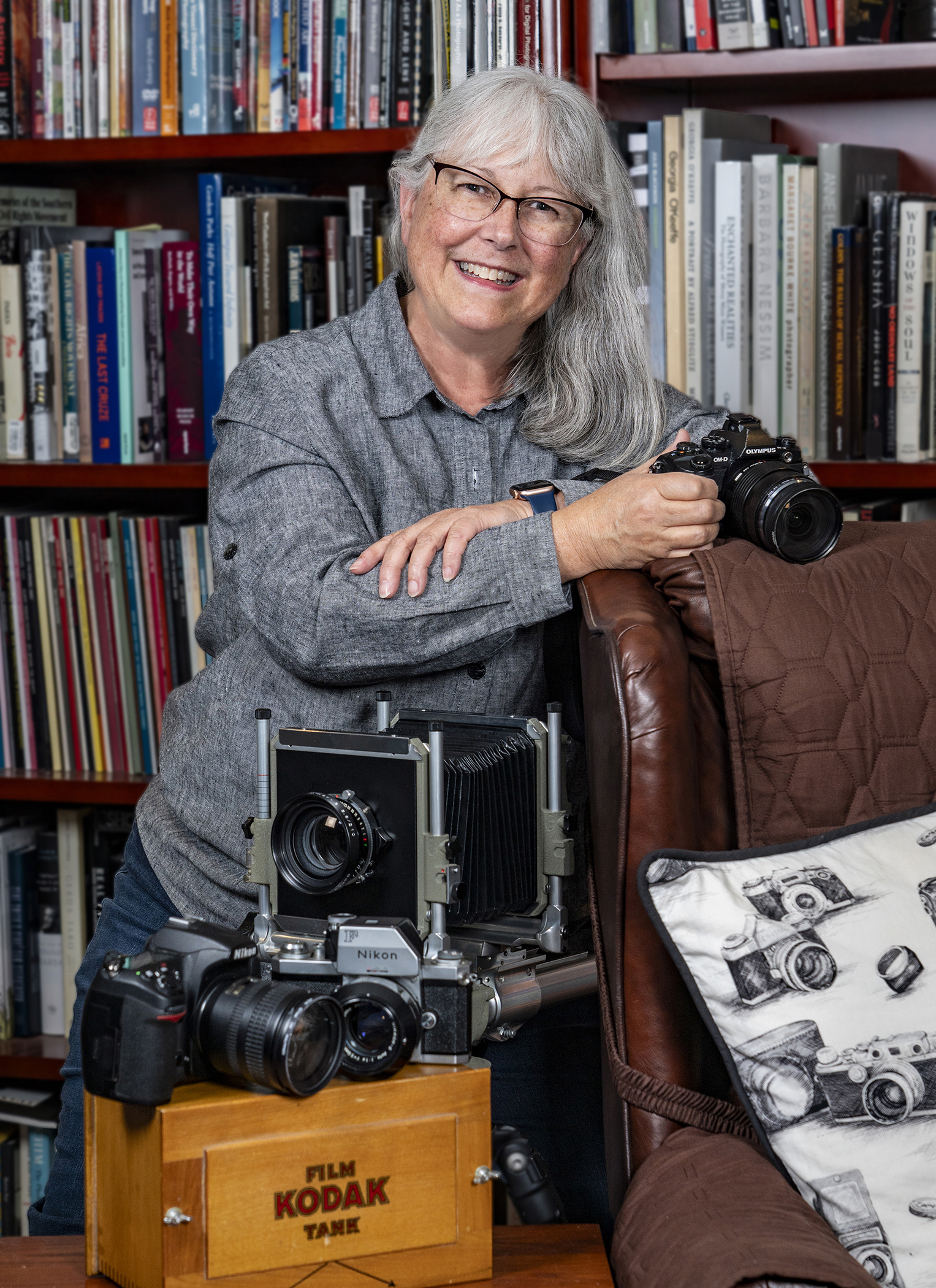 A portrait of photographer Benita VanWinkle with her cameras