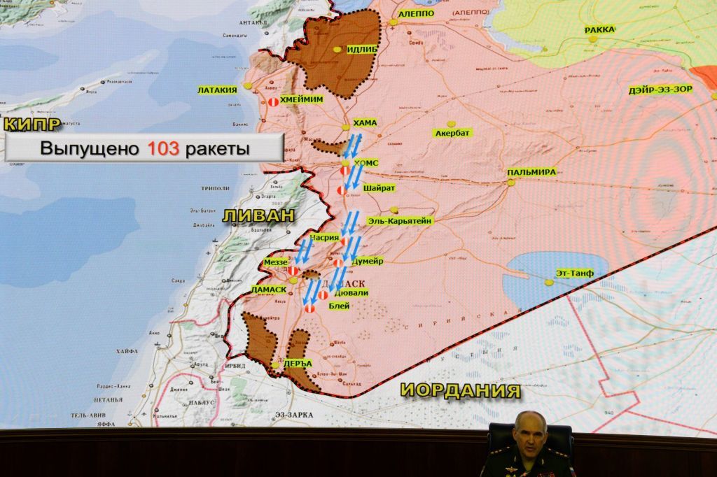 Russia&amp;#039;s senior military officer Sergei Rudskoi sits bellow a map of Syria screened during a briefing at the Russian Defence Ministry headquarters in Moscow on April 14, 2018, following overn