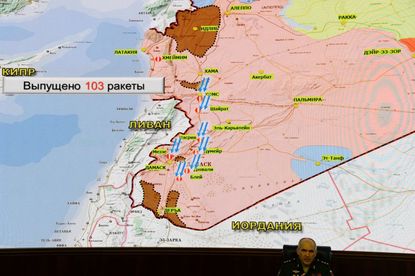 Russia's senior military officer Sergei Rudskoi sits bellow a map of Syria screened during a briefing at the Russian Defence Ministry headquarters in Moscow on April 14, 2018, following overn