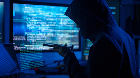 a hacker looking at a phone