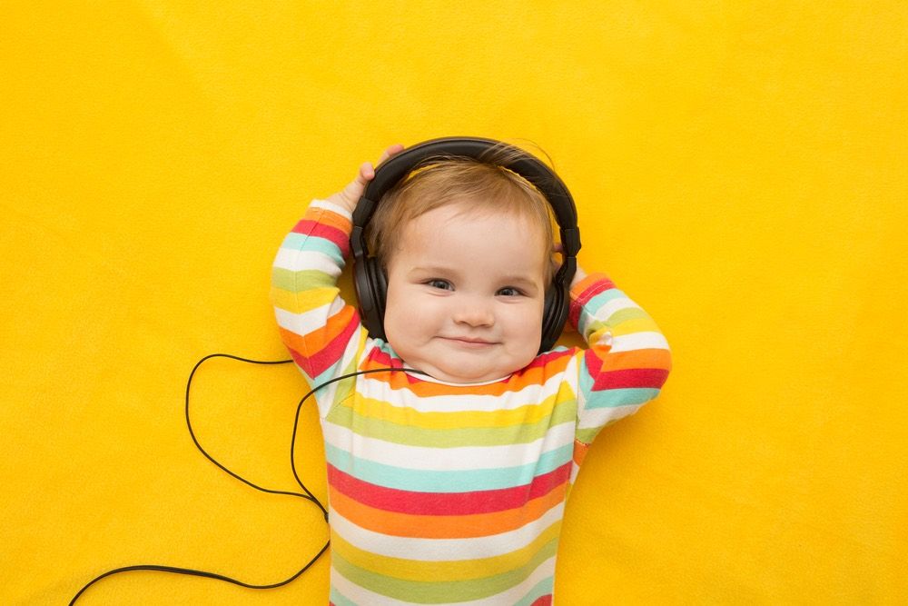 Happy baby wearing headphones.