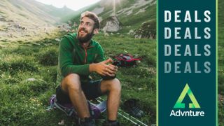 Man resting while hiking in mountainous area