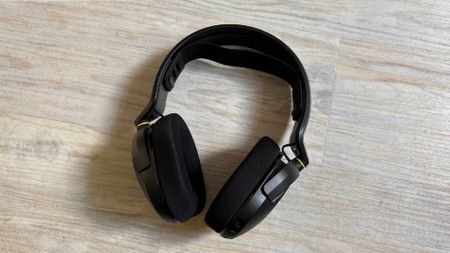 Corsair HS35 v3 headset mid shot showing entire headset with no mic attached against a white hardwood floor