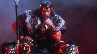 Conan the Barbarian sits on his throne at the end of his movie