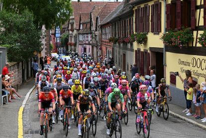 The pro women's peloton rolls through a French village