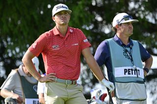 Turk Pettit stands next to his caddie and bag during LIV Golf Chicago