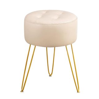 A circular white stool with gold legs