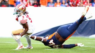 Aaron Patrick #94 of the Denver Broncos dives to attempt a tackle against Ray-Ray McCloud III #3 of the San Francisco 49ers at Empower Field at Mile High on September 25, 2022 in Denver, Colorado.