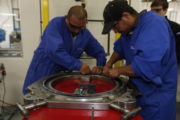 Workers lay pre-cut pieces of raw composite material into a mold. Contrary to popular belief, high-end carbon fiber production in incredibly labor-intensive - and expensive. Easton says each Haven Carbon rim costs over ten times more to produce than an alloy one.