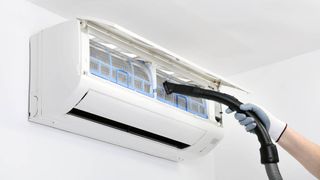Vacuum cleaning an air conditioner unit