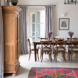 dining room with wooden table chair and floor rug