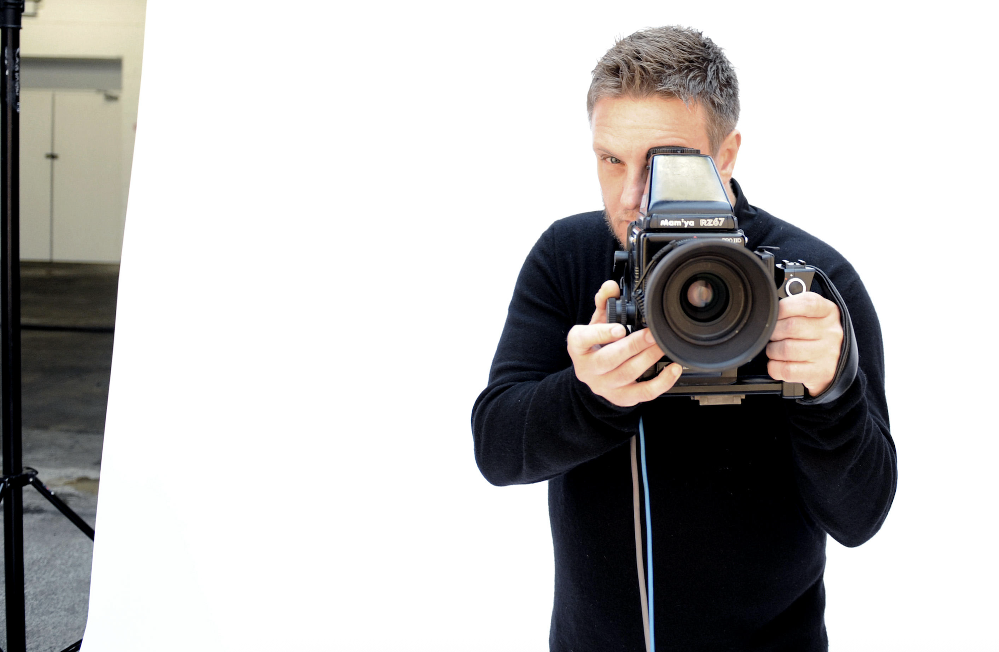 Rankin holding up a large camera