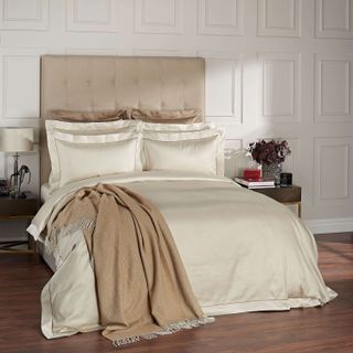 Beige bedding with gold satin piping