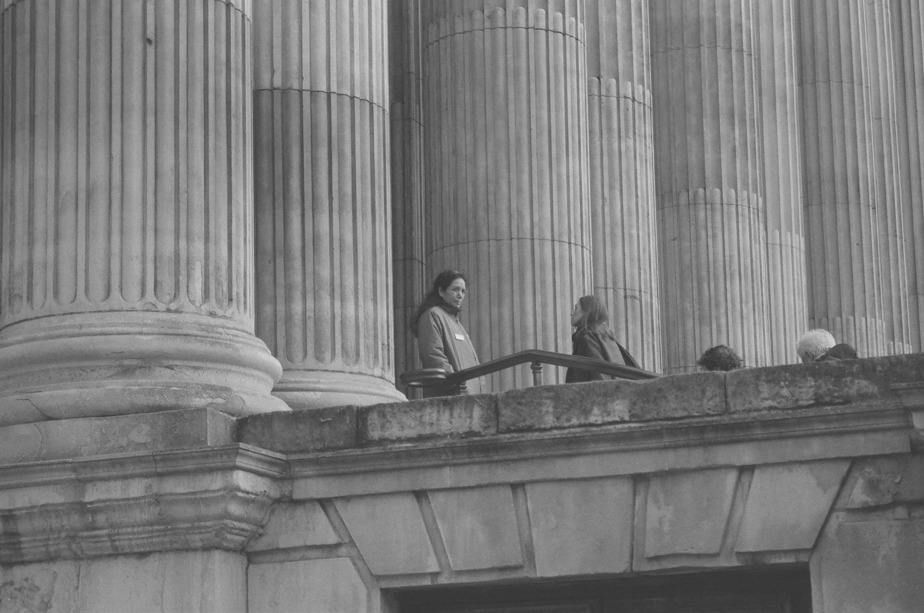 Sample photo of AgfaPhoto APX 400 35mm film showing people walking between the pillars of St Paul&#039;s Cathedral