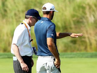 Dustin Johnson and a rules official at the 2016 US Open