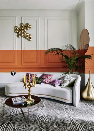 Hollywood style living room with chaise longue, golden candelabra and zebra print carpet.