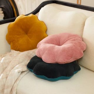 Three Urban Outfitters Dahlia Corduroy Throw Pillows in yellow, pink, and navy on a sofa