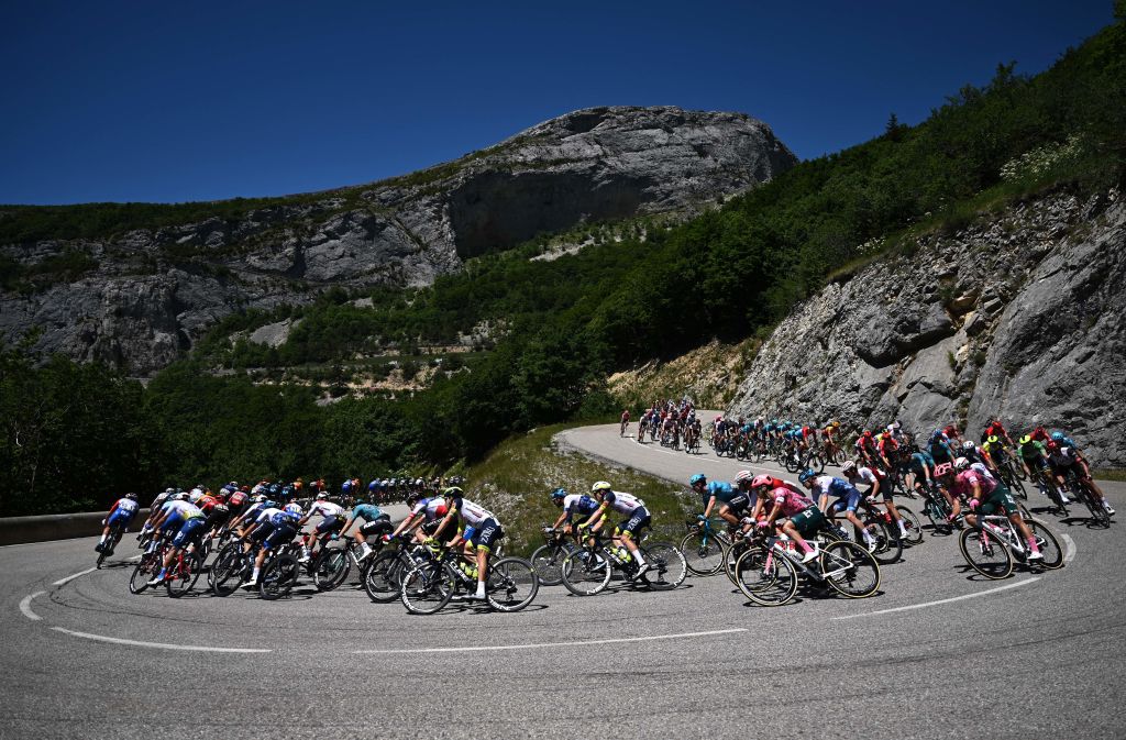 The pack of riders cycles during the sixth stage of the 74th edition of the Criterium du Dauphine cycling race 1965 km between Rives and Gap central eastern France on June 10 2022 Photo by Marco BERTORELLO AFP Photo by MARCO BERTORELLOAFP via Getty Images