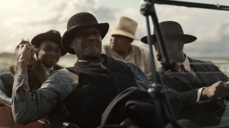 Delta Slim (Delroy Lindo), Stack (Michael B. Jordan), Sammie (Miles Caton) and Cornbread (Omar Benson Miller) drive along the road in Sinners