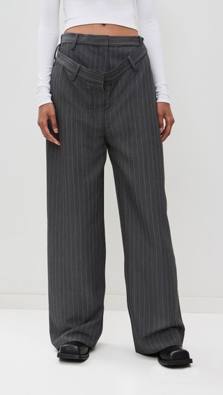 a model wears gray pinstripe pants