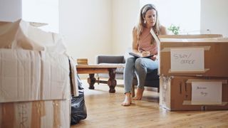 A woman labelling some boxes