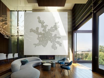 Main double height living space with large white artwork at Art House