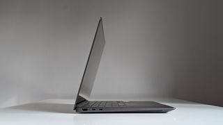 The side view of a Samsung Galaxy Book3 Ultra on a white desk