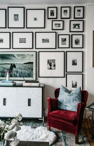 living room with red chair and gallery wall