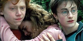 Harry Potter trio Ron Hermione Harry Hermione crying into Ron shoulder Warner Bros.
