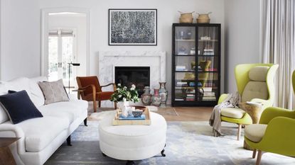 Living room with contemporary style looking to green armchairs and fireplace