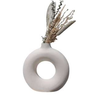 white ceramic vase in circular shape