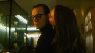 cate blanchett whispers in michael fassbender's ear in a darkly lit room in the movie black bag