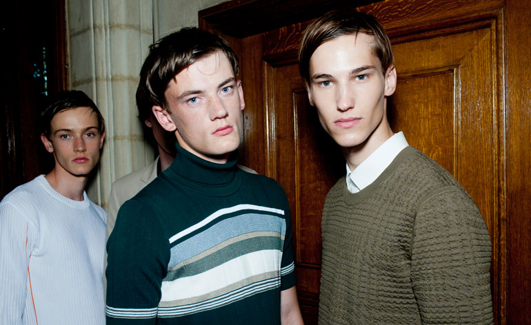 Three male models wearing sweaters