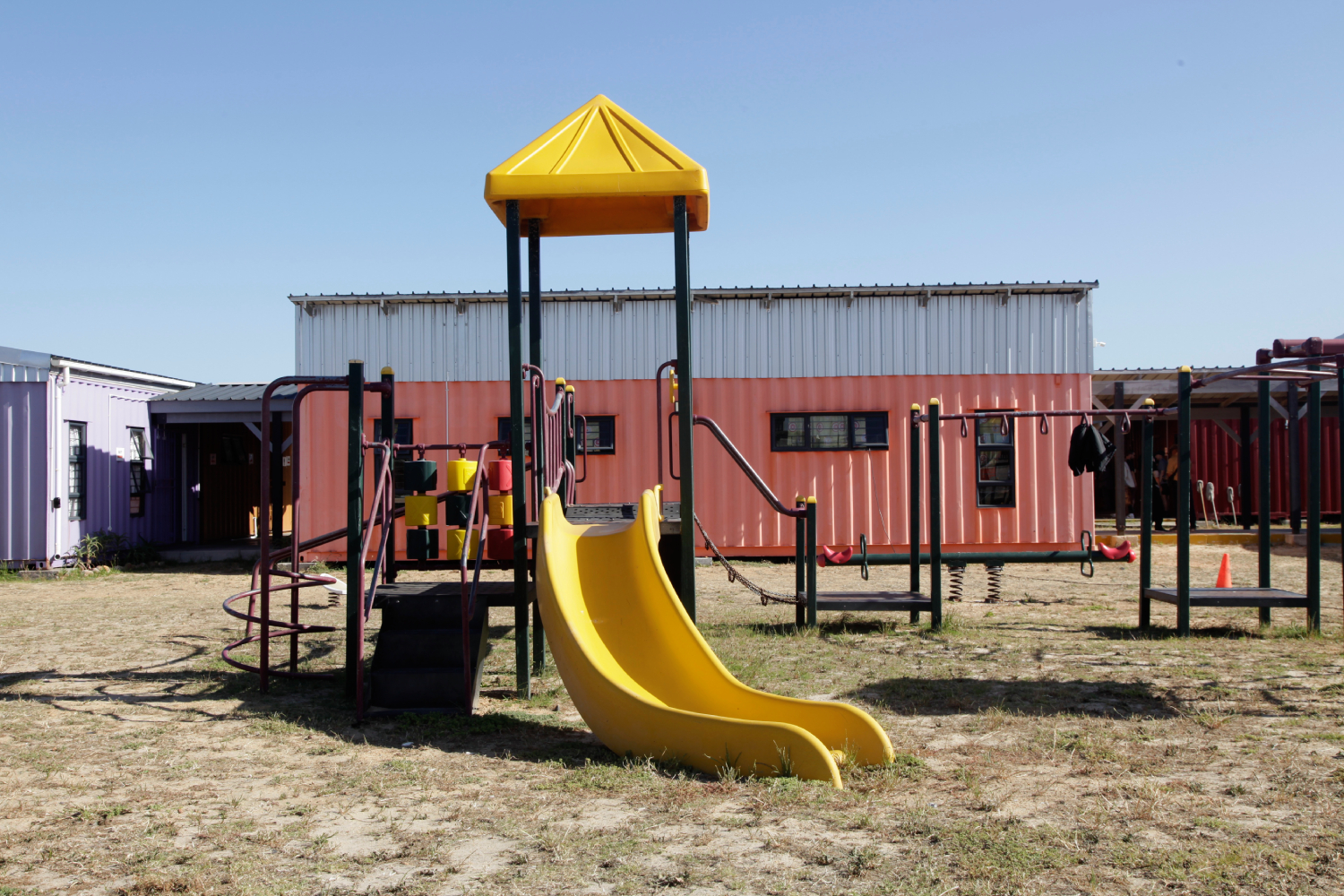 In PAB, a playground and brightly coloured houses made from repurposed shipping containers offer children a space to carefree and play, without fear of violence.