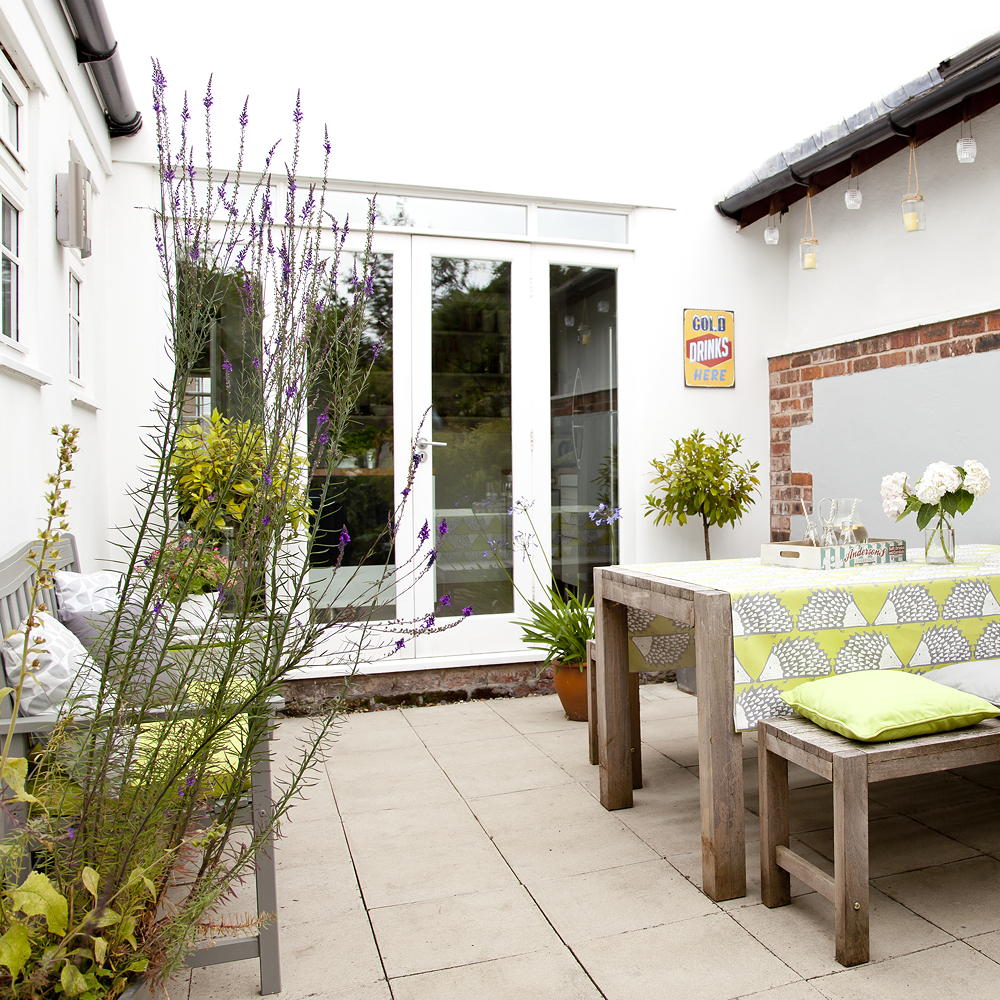 outside area with wooden table and tiles flooring