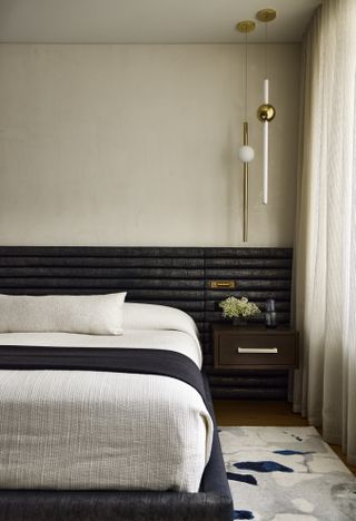 A bed with textured headboard