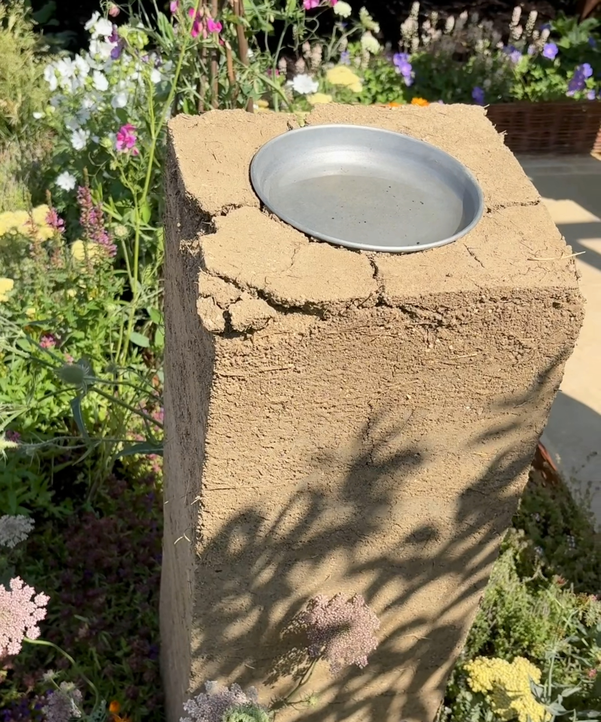 DIY bird bath in a border