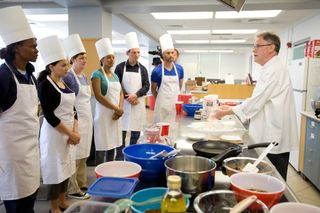 Participants preparing for a mock mission to Mars take cooking lessons for the journey at a Cornell University kitchen lab.