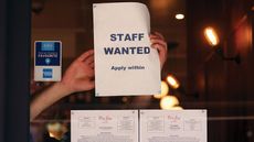 "Staff wanted" notice in a restaurant window
