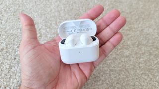 best fake airpods: The Denon AH-C830NCW charging case held in hand