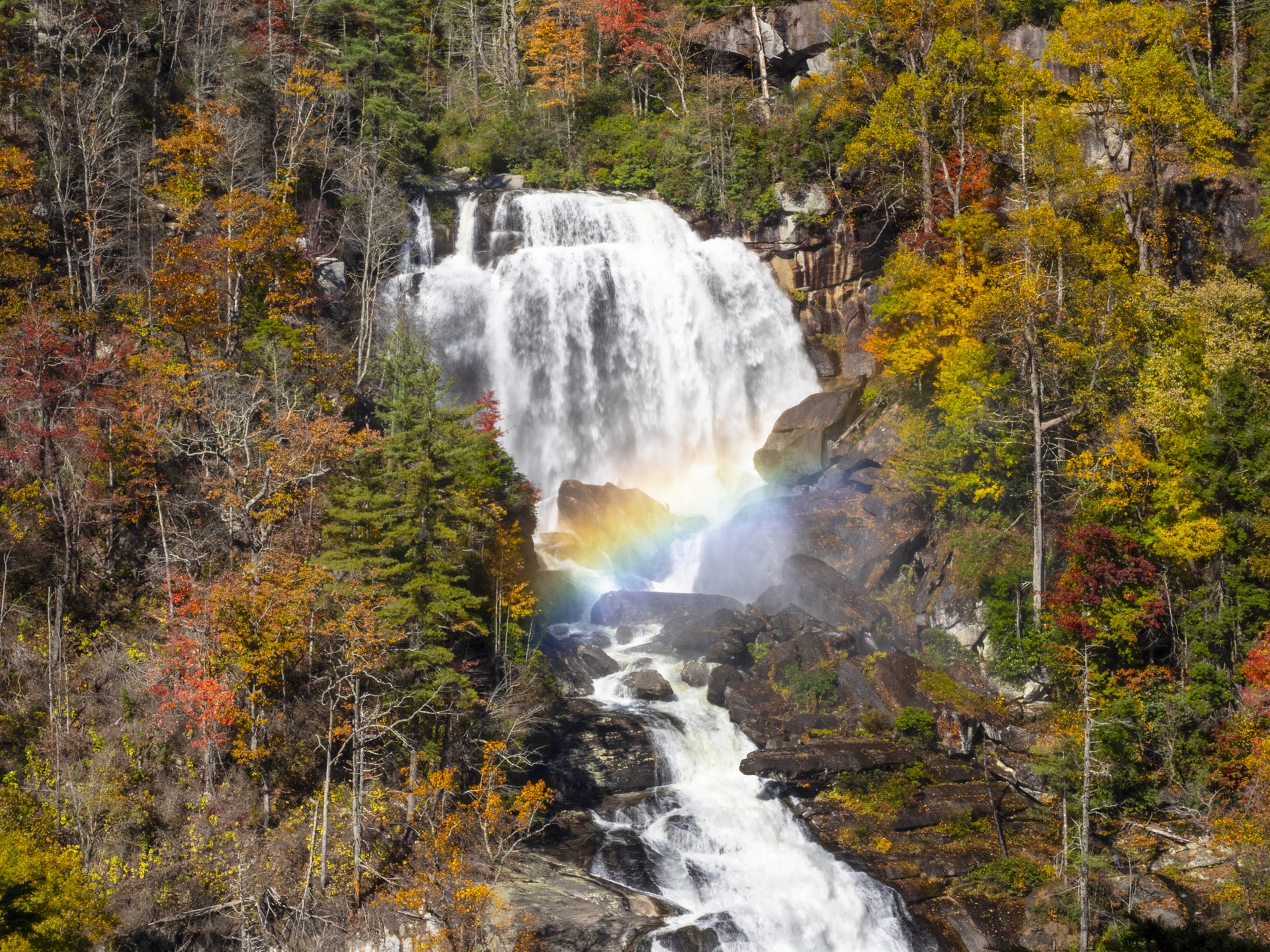 Whitewater Falls with a rainbow stretching over the rocks
