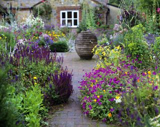 how to plan a cottage garden pot on tiled path