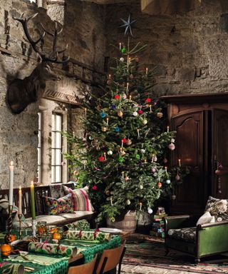 Christmas tree in dining room with stone walls and floors