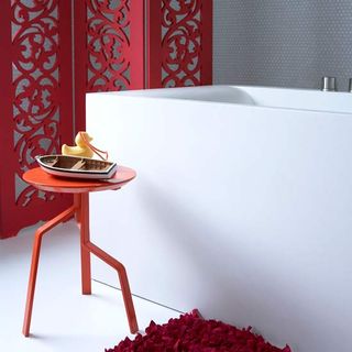 bathroom with white flooring and deep red decorative screen and red bath mat